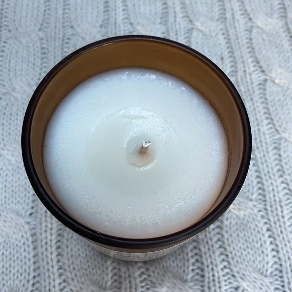 NWOT Vanilla Sandalwood candle. 10 0z. Hand poured amber glass wood lid one wick